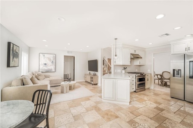 kitchen with under cabinet range hood, visible vents, open floor plan, light countertops, and appliances with stainless steel finishes