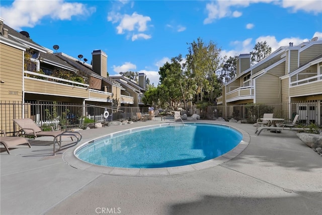 pool featuring a patio and fence