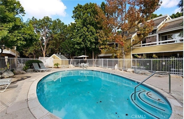 pool featuring a patio and fence