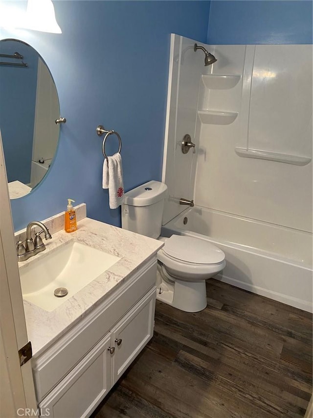 full bathroom featuring shower / tub combination, vanity, toilet, and wood finished floors