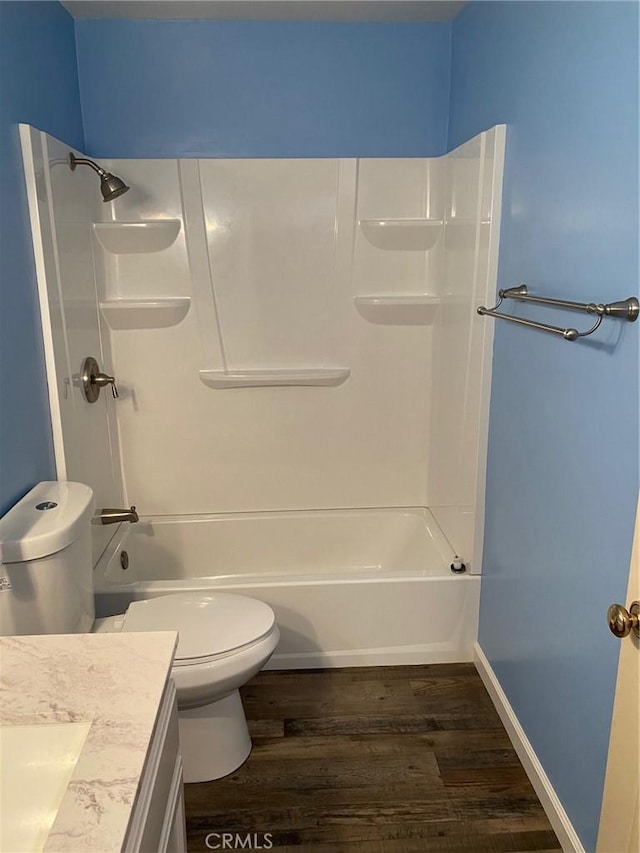 bathroom with shower / bathtub combination, vanity, toilet, and wood finished floors