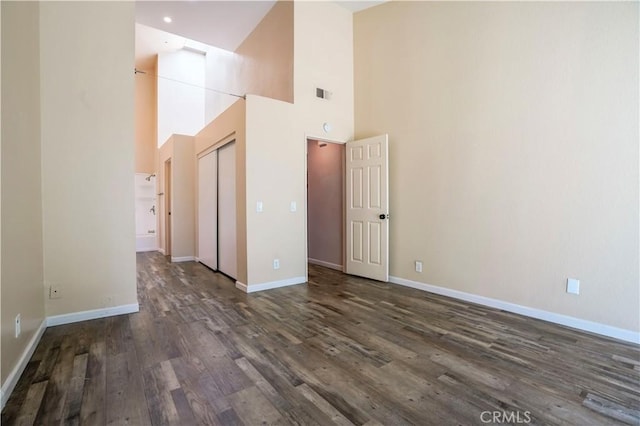 3690 S Bear St Unit 5, Santa Ana, CA 92704 - empty room with baseboards, dark wood finished floors, a high ceiling, and visible vents