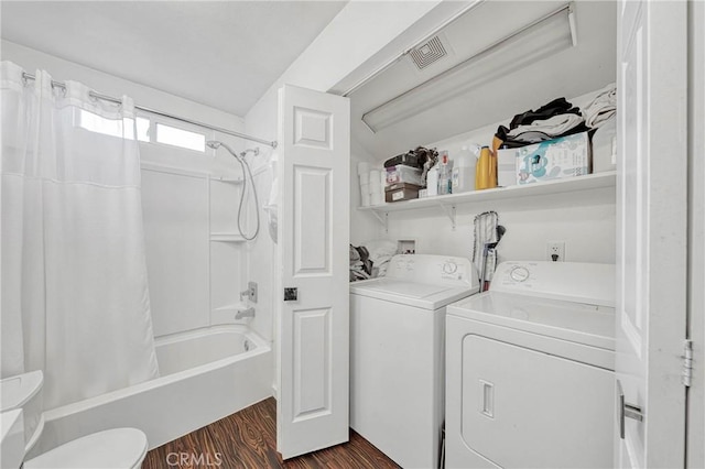 laundry area featuring laundry area, dark wood-type flooring, and washing machine and clothes dryer