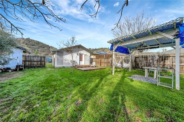 view of yard with a fenced backyard and a wooden deck