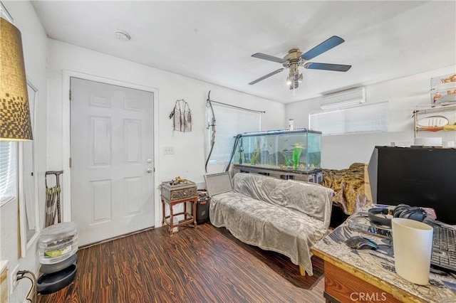 bedroom featuring an AC wall unit, wood finished floors, and a ceiling fan