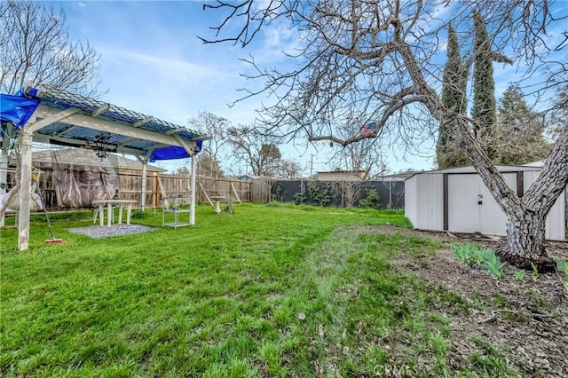 view of yard with a shed, an outdoor structure, and a fenced backyard