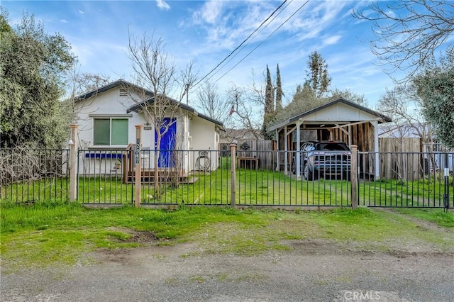 bungalow-style home with a fenced front yard, a gate, a front lawn, and a carport