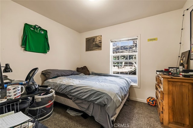 bedroom featuring carpet and baseboards