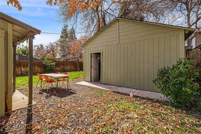 view of outbuilding with a fenced backyard and an outdoor structure