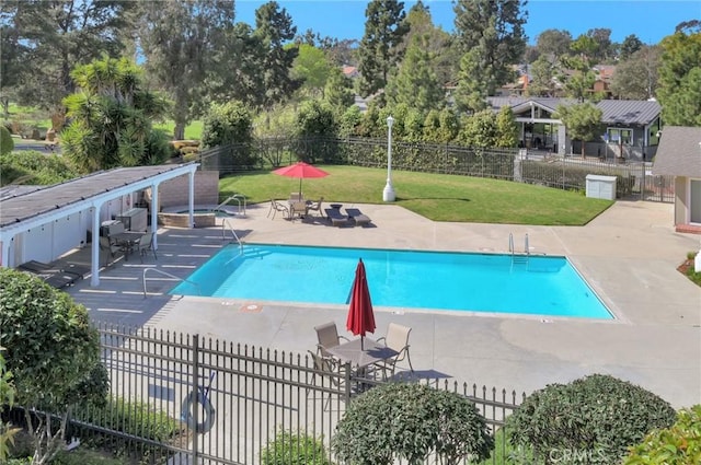 pool with fence, a lawn, and a patio