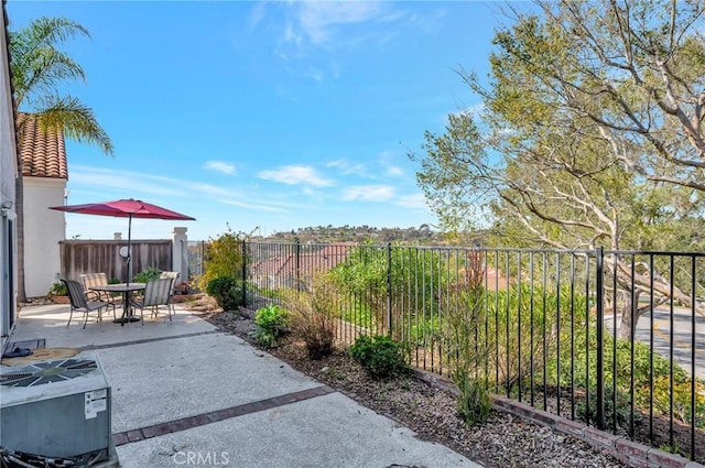 view of patio / terrace featuring central AC, outdoor dining area, and a fenced backyard