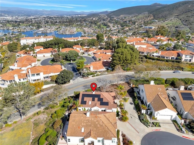 drone / aerial view with a residential view and a water and mountain view