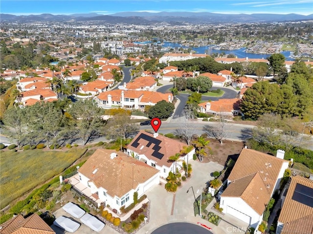 aerial view featuring a residential view and a water and mountain view