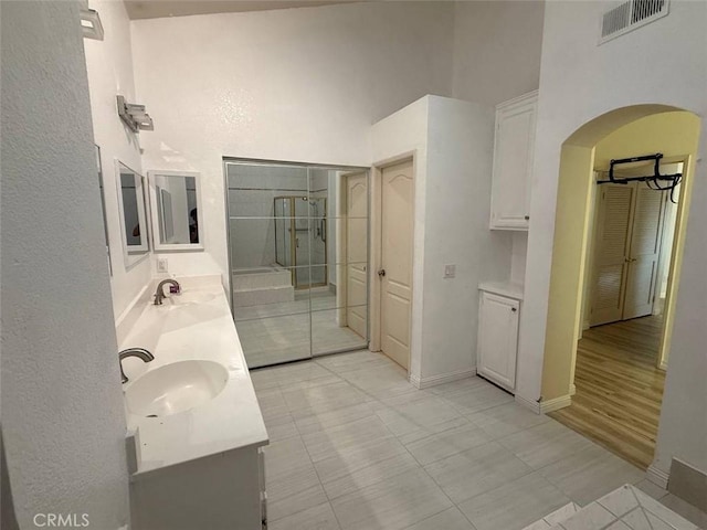1268 Via, San Jacinto, San Marcos, CA 92078 - full bathroom with double vanity, a towering ceiling, an enclosed shower, and tile patterned floors