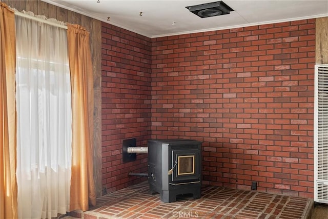 interior details with ornamental molding and a wood stove