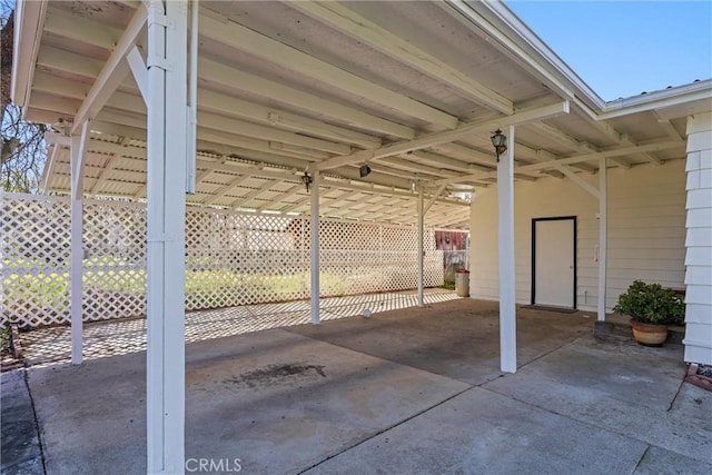 view of patio featuring a carport and driveway