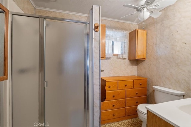 bathroom featuring crown molding, toilet, a stall shower, ceiling fan, and vanity