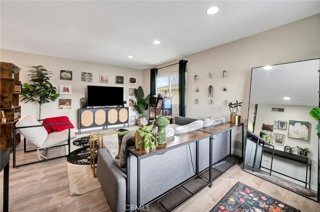 living room with wood finished floors and recessed lighting