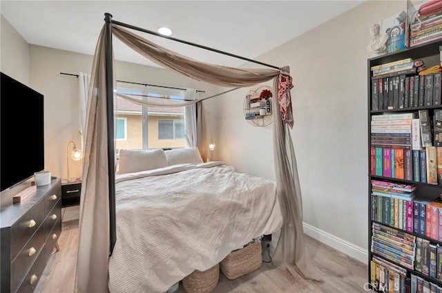 bedroom featuring baseboards and wood finished floors