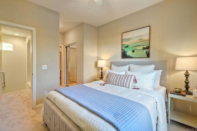 bedroom with a closet, light colored carpet, and ceiling fan