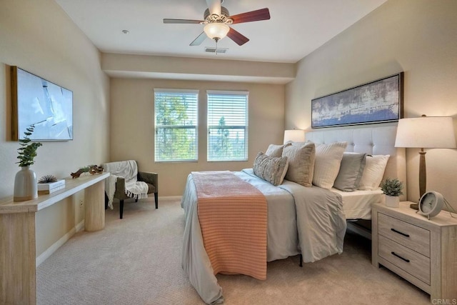 bedroom featuring baseboards, visible vents, ceiling fan, and light colored carpet