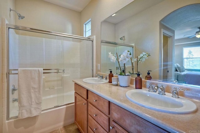 bathroom with double vanity, shower / bath combination with glass door, a sink, and tile patterned floors