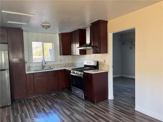 kitchen featuring wall chimney exhaust hood, appliances with stainless steel finishes, dark wood-type flooring, and a sink