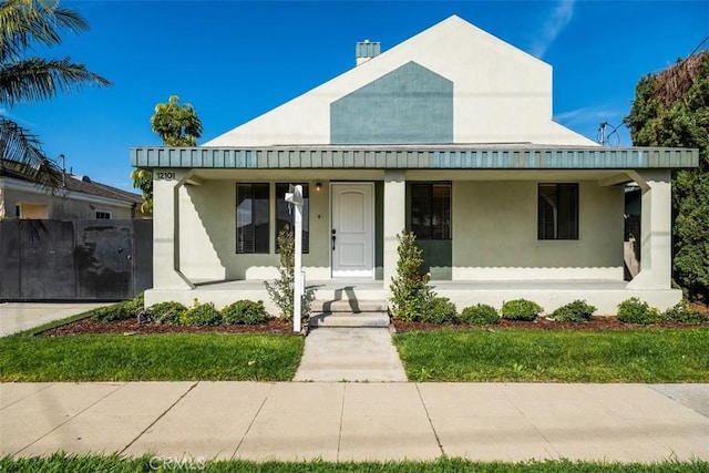 view of front facade with covered porch and stucco siding