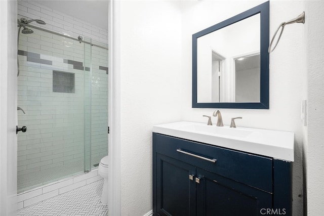 bathroom with tile patterned flooring, a shower stall, toilet, and vanity