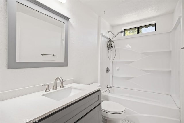 bathroom with toilet, washtub / shower combination, a textured ceiling, and vanity