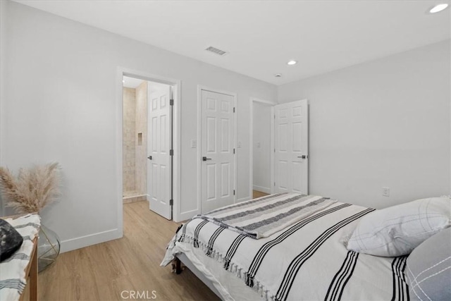 bedroom with light wood-style floors, baseboards, visible vents, and recessed lighting