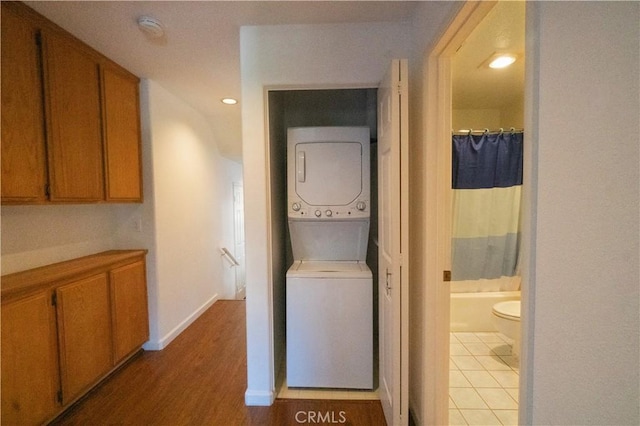 20271 Sealpoint Unit 104, Huntington Beach, CA 92646 - corridor featuring baseboards, recessed lighting, stacked washer / drying machine, and light wood finished floors