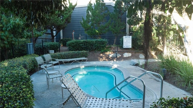 20271 Sealpoint Unit 104, Huntington Beach, CA 92646 - view of swimming pool with fence and a community hot tub