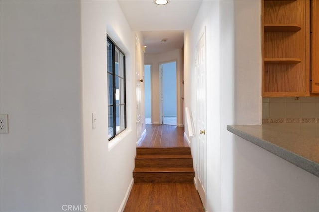 20271 Sealpoint Unit 104, Huntington Beach, CA 92646 - hall with recessed lighting, stairs, wood finished floors, and baseboards