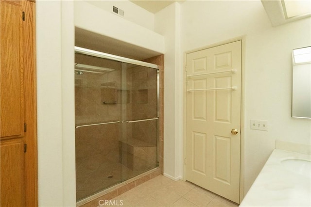 20271 Sealpoint Unit 104, Huntington Beach, CA 92646 - full bath with visible vents, a shower stall, tile patterned flooring, and vanity