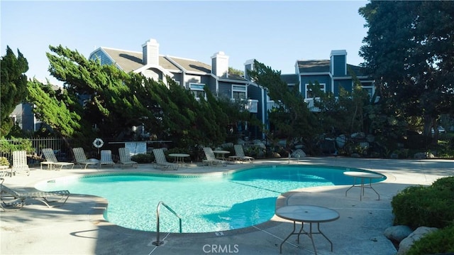 pool with fence and a patio