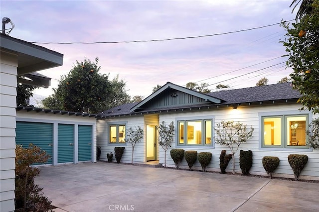 back of house featuring board and batten siding and a patio