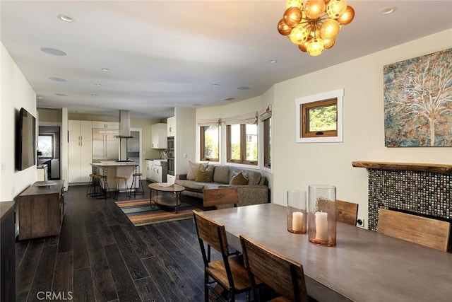 dining room featuring recessed lighting, dark wood-style flooring, and a notable chandelier