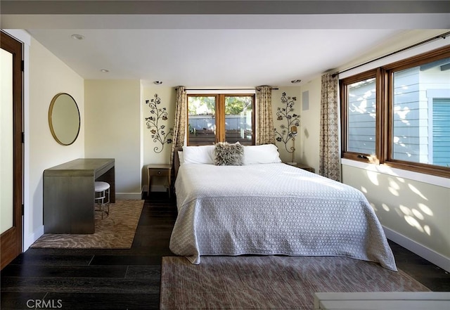 bedroom with baseboards and wood finished floors