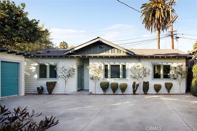 single story home featuring a patio area and board and batten siding