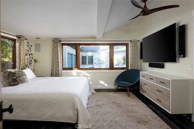 bedroom featuring beam ceiling, multiple windows, and baseboards