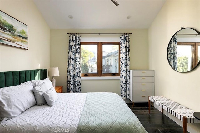 bedroom featuring vaulted ceiling and dark wood-type flooring