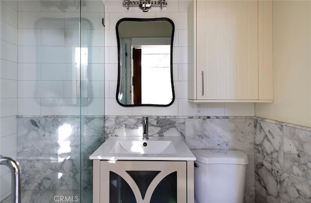 full bath featuring toilet, a shower stall, tile walls, and vanity