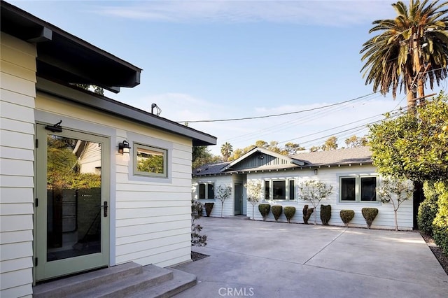 view of side of property featuring a patio