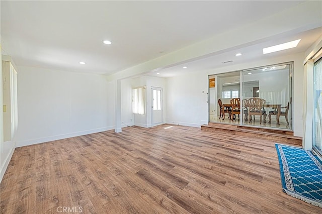 empty room featuring baseboards, wood finished floors, and recessed lighting