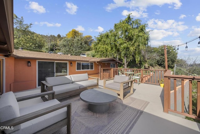 wooden terrace featuring outdoor lounge area