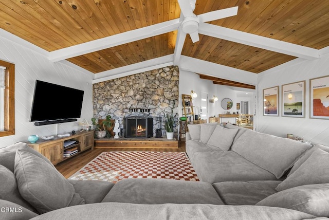 living room with lofted ceiling with beams, a fireplace, wood finished floors, wood ceiling, and a ceiling fan