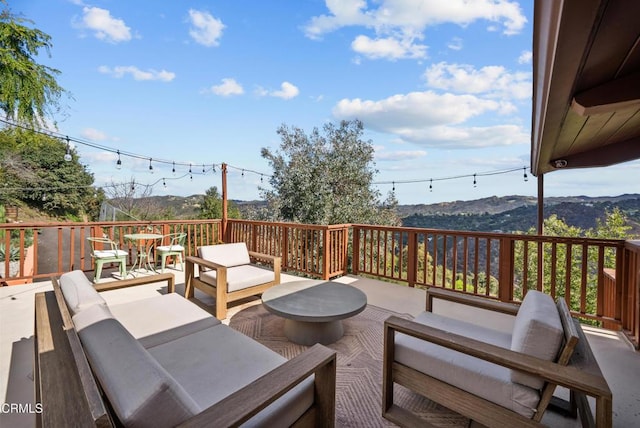 deck with a mountain view and outdoor lounge area