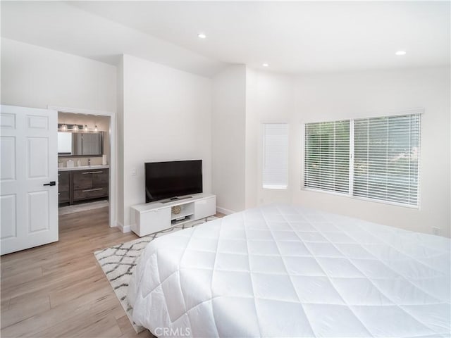 bedroom with vaulted ceiling, recessed lighting, baseboards, and light wood-style floors