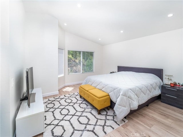 bedroom with recessed lighting, vaulted ceiling, baseboards, and wood finished floors